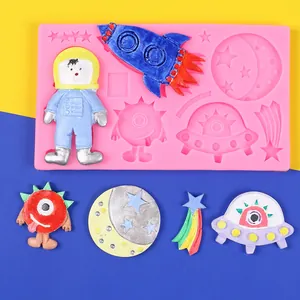 Pink silicone space-themed mold for DIY cake decoration with astronaut and rocket shapes