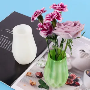 Silicone vase mold for resin DIY alongside a finished green geometric flower pot.