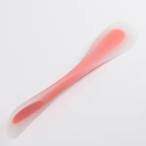 Detail view of a translucent pink silicone spatula with a nylon core for baking.