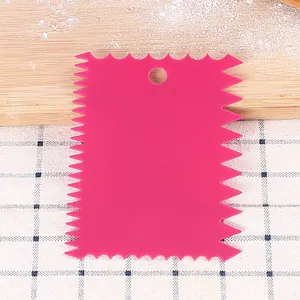 Close-up macro view of pink plastic serrated cake scraper for DIY kitchen baking tools