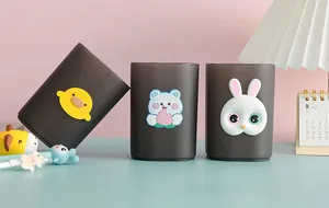 Detail view of cartoon animal pen holders with frosted finish and cute 3D charms