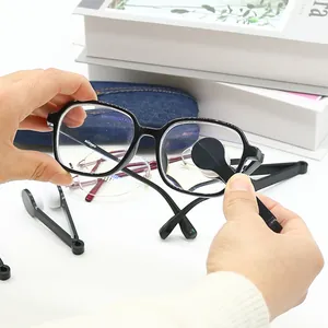 Close-up showing the portable eyeglass lens cleaner tool in use on black frames