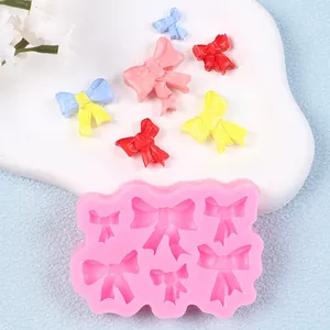 Molde de silicona rosa con diseños de lazos para decoraciones de pasteles
