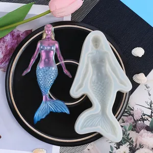 Detailed view of translucent silicone mermaid mold with finished gradient resin figure