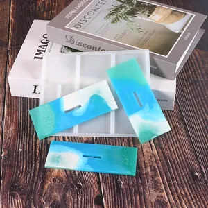 Close-up of rectangular silicone mold and ocean-themed resin pieces for DIY crafts