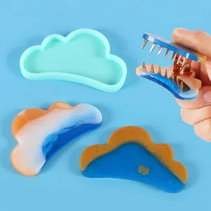 Detailed view of cloud-shaped DIY silicone mold and finished colorful resin hair clips