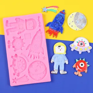 Space-themed silicone mold detail with astronaut, rocket, and UFO shapes for cake decor.