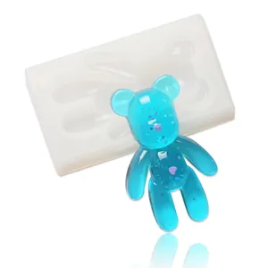 Translucent bear silicone mold shown with a finished blue glitter resin bear craft