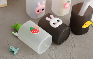 Macro view of cute cartoon pencil holders with 3D animal figures on a textured grey desk
