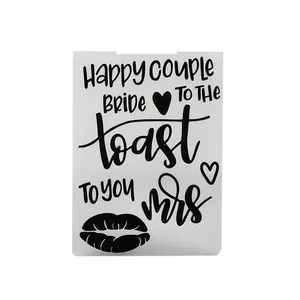 Close-up of a hollowed-out drawing stencil featuring romantic wedding themed English phrases