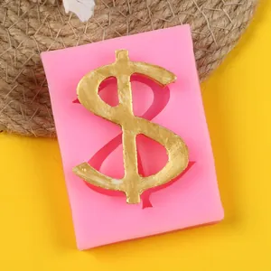 Close-up macro view of pink silicone mold with a golden dollar sign for DIY cake decoration.