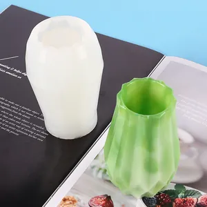 Detail view showing a white silicone vase mold and a finished green resin vase