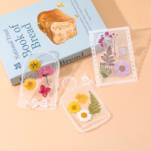 Creative transparent DIY dried flower bookmarks in bottle and frame shapes on desk