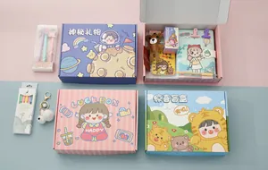 Detailed view of four cute stationery gift boxes with notebooks, pens, and keychains.