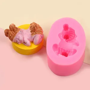 Detailed macro view showing the pink silicone baby mold alongside a finished plaster craft piece