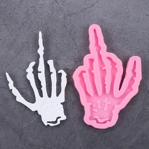 Detail view of pink silicone skeleton hand mold making a middle finger gesture for Halloween