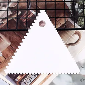 White triangular plastic dough scraper with serrated edges for cake baking DIY tools