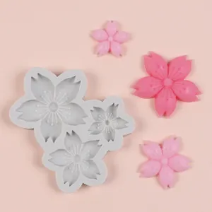 Detailed view of cherry blossom silicone mold with pink resin flower cast samples