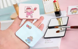 Detailed view of cute portable double-sided folding makeup mirrors with cartoon illustrations