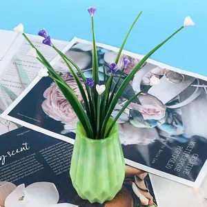 Close-up of geometric green resin vase with decorative flowers made from DIY mold