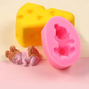 Detailed macro view of pink baby-shaped silicone mold and the finished plaster figure.