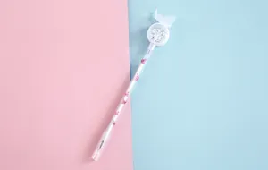 Detail view of a cute butterfly gel pen with sparkling sequins and pink wing patterns