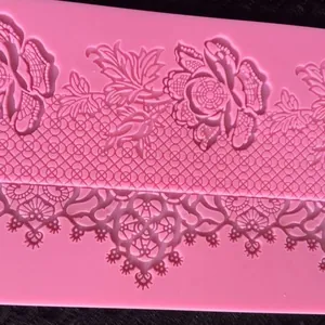 Macro view showing the intricate lace and floral details of a pink silicone baking mold