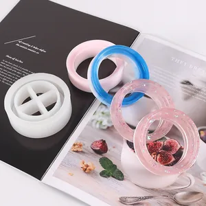 Detail view of a DIY resin silicone mold alongside colorful finished ring crafts