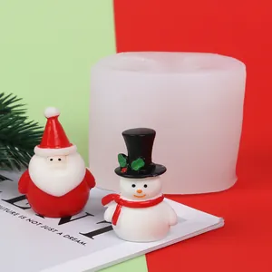 Close-up view of a DIY Christmas silicone mold featuring Santa Claus and Snowman candle figurines