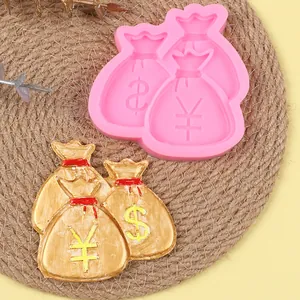 Close-up of pink money bag silicone mold with dollar and yen symbol patterns