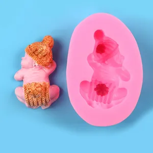 Detailed view of baby-shaped silicone mold and finished resin cast showing intricate textures