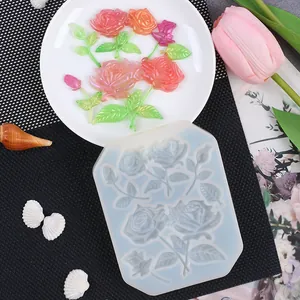 Detailed view of a 3D DIY rose flower silicone mold shown with finished resin pieces