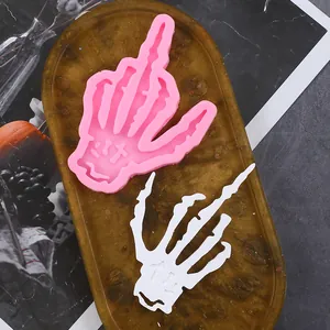 Detail of a pink skeleton hand silicone mold with a middle finger gesture for Halloween DIY.