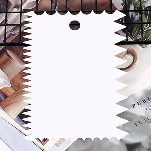 White plastic jagged edge cake scraper tool for professional baking and DIY crafts