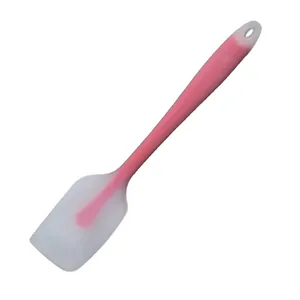 Detailed close-up view of a pink and translucent silicone cream spatula for baking
