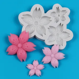 Detailed view of cherry blossom silicone mold with pink resin flower samples for DIY