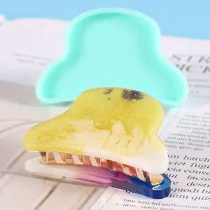 Close-up of DIY silicone hair clip mold with a finished glitter resin accessory