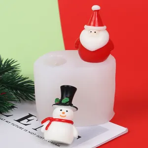 Close-up of DIY Christmas Santa and snowman silicone candle mold with finished samples