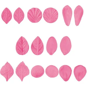 Detailed view of various pink silicone petal and leaf molds for fondant cake decoration.