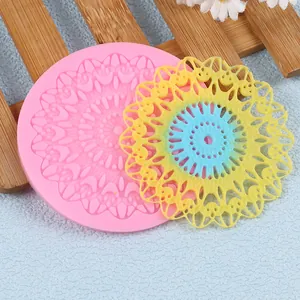 Detailed macro view of a pink circular silicone lace mold with intricate floral mandala patterns