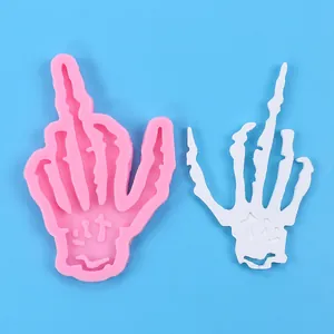 Detailed view of a Halloween skeleton hand silicone mold with its white finished product