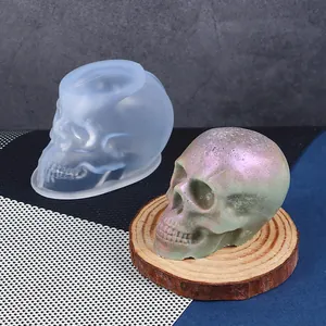 Detailed view of the skull silicone mold with a finished iridescent resin skull model