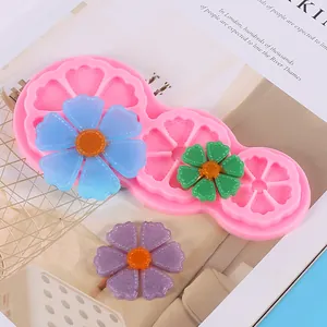 Detailed view of a pink silicone flower mold with resin sunflower pieces for DIY crafts