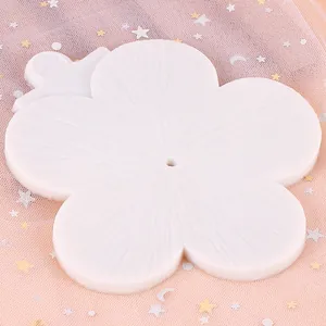 Detailed view of a white flower-shaped silicone mold with fine textured petals