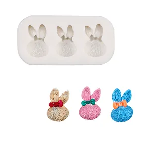 Detailed view of a 3-cavity cartoon bunny silicone mold with colorful finished samples
