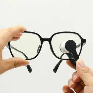 Macro detail of portable microfiber lens cleaning tool wiping black glasses frame