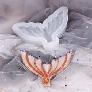 Close-up view of mermaid tail silicone mold with a finished decorative resin craft.