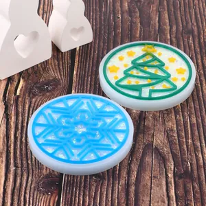 Detail view of DIY resin coasters with sparkling Christmas tree and snowflake designs.