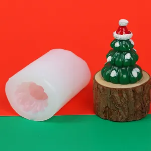 Detail showing a white silicone mold alongside a finished Christmas tree candle
