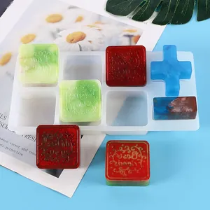 Detalle de molde de silicona DIY y sellos de resina con saludos grabados en inglés